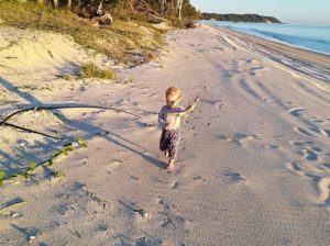 toddler running on beach 